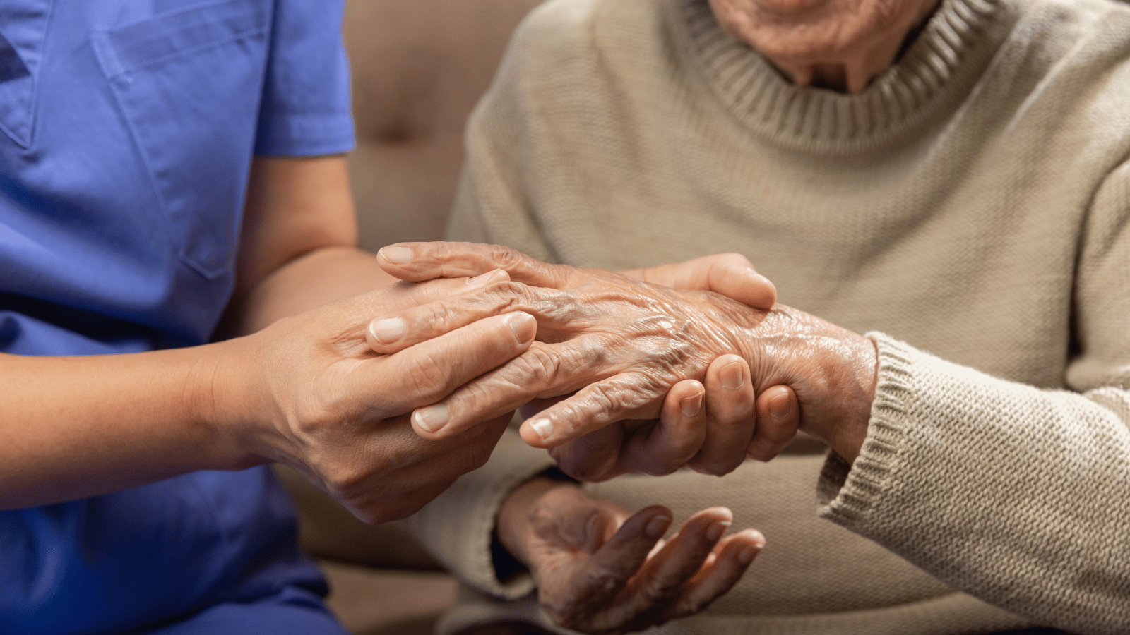 Nurse massaging patient's hands