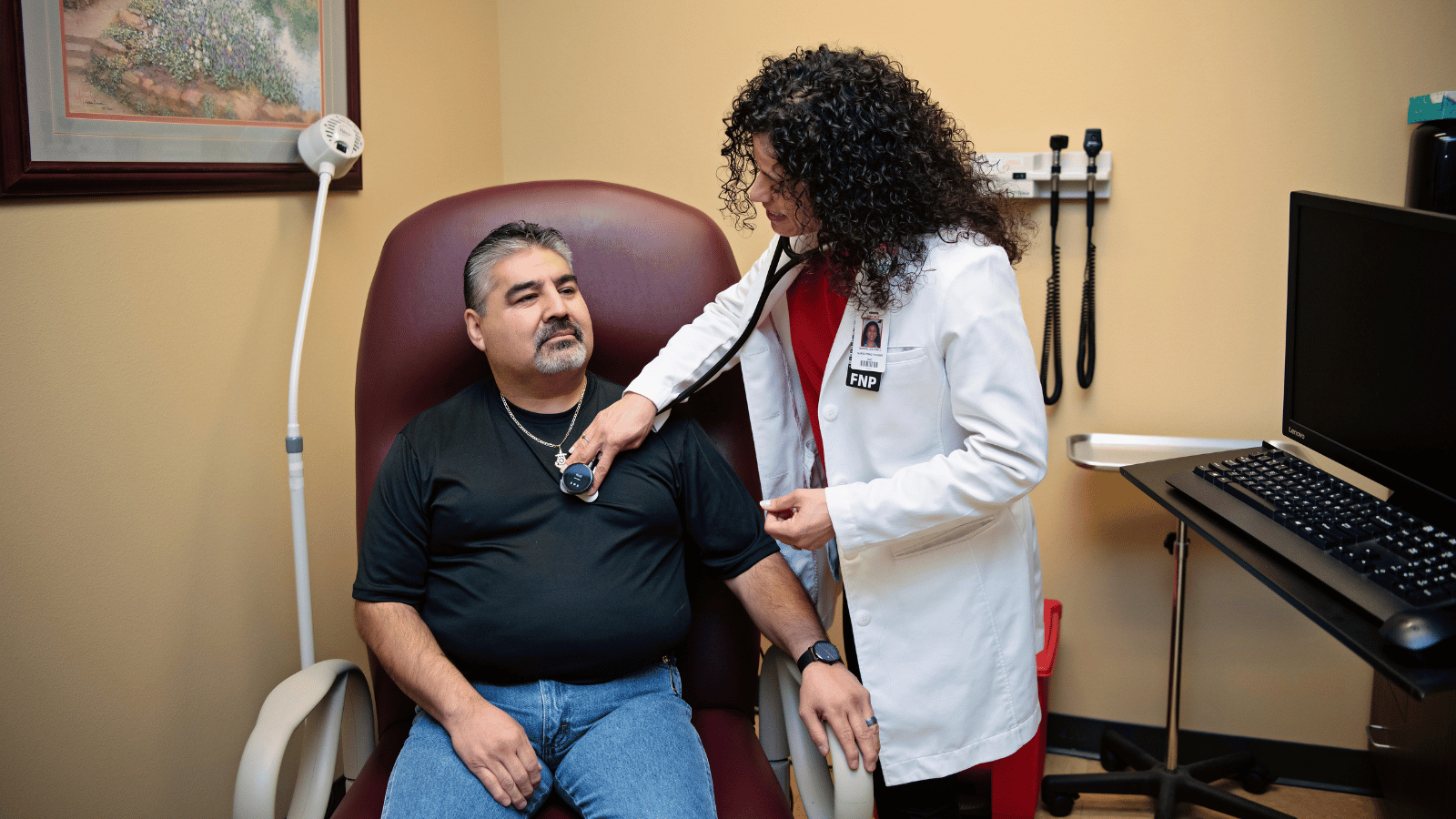 Nurse listening to patient's heart with a stethoscope