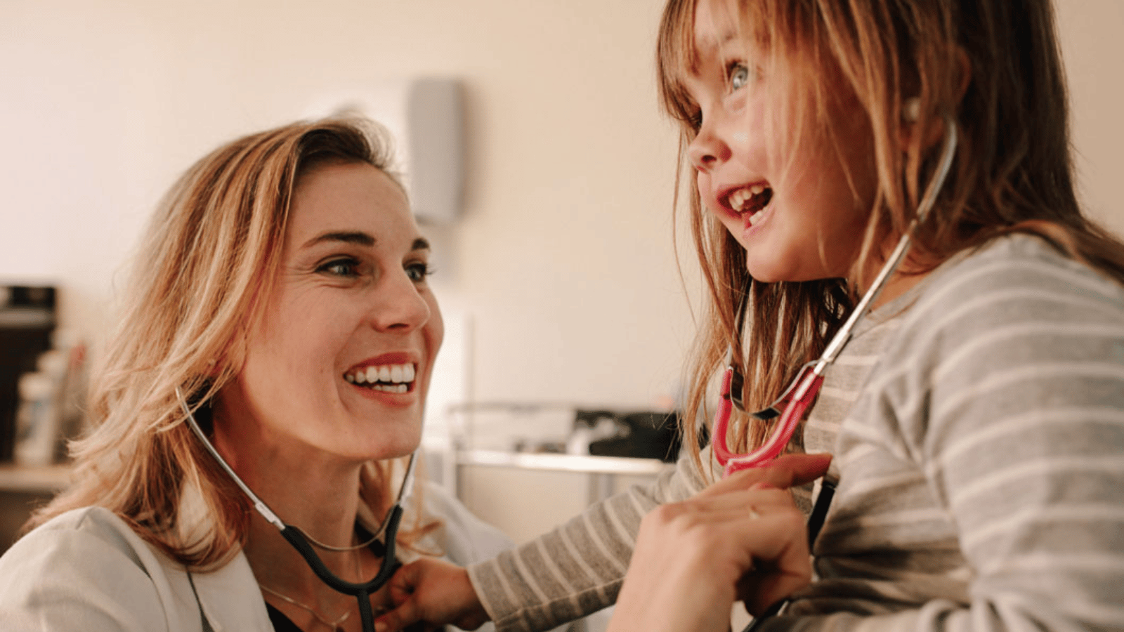 Doctor listening to child's heart with a stethoscope during a wellness visit