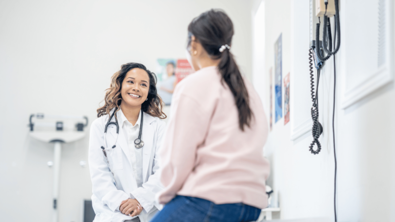 Doctor talking to female patient in clinic